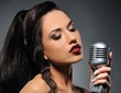 Beautiful brunette woman singing . Beautiful brunette woman singing .