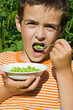 Boy eating peas