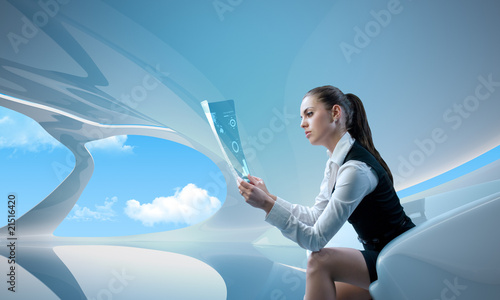 Photo: Sexy businesswoman examining future digital report / newspaper Sexy businesswoman examining future digital report / newspaper