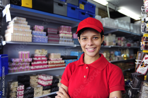 Photo: young woman working in a gift box store young woman working in a gift box store