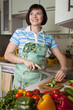 Woman cutting vegetables in the kitchen.