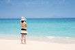 Photo: A beautiful woman wearing a bikini facing the sea A beautiful woman wearing a bikini facing the sea