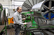 Older workers in the metal industry with CNC milling machine.