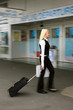 Blonde woman on her way to the departure airport