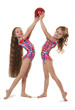 Two little girls gymnasts with the ball