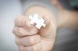 Hand giving puzzle piece