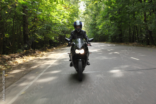 Photo: motorcyclist goes on road, front view motorcyclist goes on road, front view