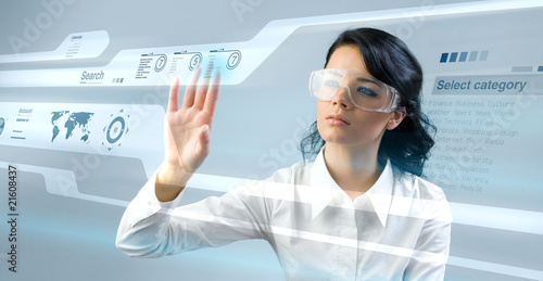 Photo: Pretty young lady using new technologies Pretty young lady using new technologies