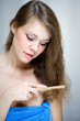 Attractive woman combing her hair