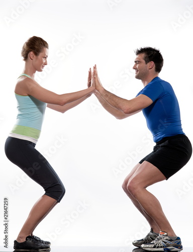 Photo: couple, man and woman doing workout on white isolated background couple, man and woman doing workout on white isolated background