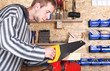 Portrait of a workman holding handsaw Portrait of a workman holding handsaw