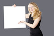 Blonde Frau präsentiert mit weisser Tafel, horizontal