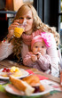 Young mother and baby daughter having breakfast together in a Pa