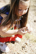 Child Exploring & Collecting Rocks