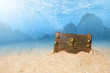 photo of treasure chest submerged underwater with light rays