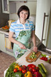 Woman cutting vegetables in the kitchen.