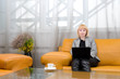 blonde woman with laptop in comfort hall