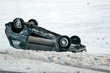 Car turned upside-down on slippery winter road Car turned upside-down on slippery winter road
