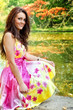 Woman with beautiful colorful dress near lake