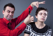 Man examining woman's hair with magnifying glass Man examining woman's hair with magnifying glass