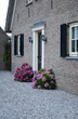 The outside of a home with flowers in front The outside of a home with flowers in front