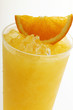 Orange juice with crushed ice and wedge of orange (close-up)