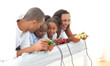 Foto: Lively family playing video game lying down on bed Lively family playing video game lying down on bed