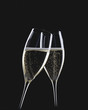 Two glasses of sparkling wine being clinked together