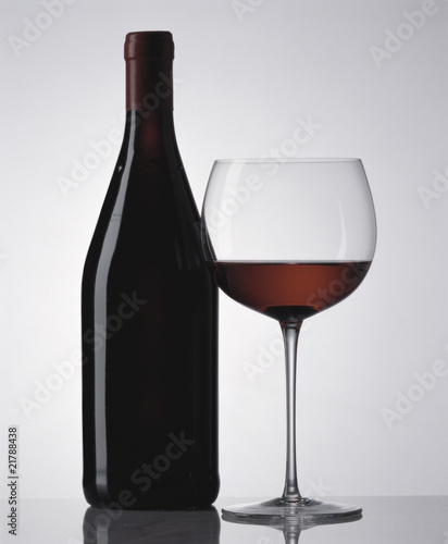 Photo: Glass of red wine and red wine bottle Glass of red wine and red wine bottle