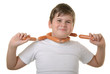Happy boy has wrapped up sausages round neck