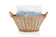 White and blue towels in a laundry basket on white