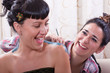 Hispanic women having fun while body painting