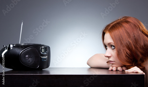 Photo: Young woman listening radio Young woman listening radio