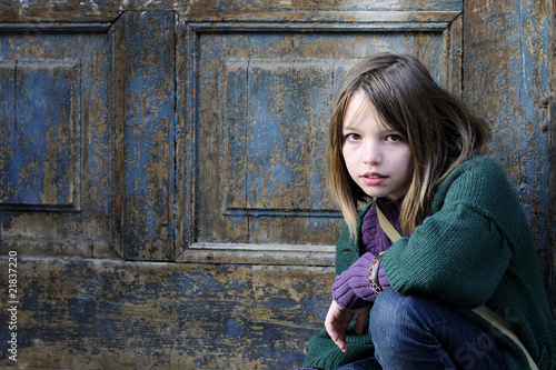 Photo: beautiful girl posing with old door in background beautiful girl posing with old door in background