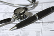 Stethoscope,  a pen and a blank prescription pad