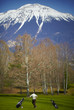 Man playing golf at the golf range with mountains for backdrop