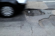 pothole in a road with car pothole in a road with car