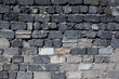 Wall of gray rough bricks