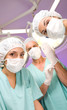 Surgeon putting gloves on