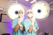 Surgeons putting on gloves