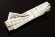 rolled up newspaper on black