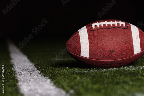 Photo: Football resting on the first down line Football resting on the first down line