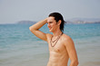 Muscular young man on the beach.