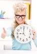 woman holding big clock