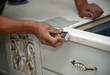 Photo: Man hand performs polishing kitchen furniture Man hand performs polishing kitchen furniture
