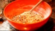 Adding oats and dried fruit to mixture to make cookies