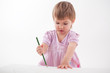 girl draws with crayons