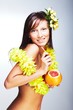 Photo: Beautiful girl with Hawaiian accessories drinking grapefruit Beautiful girl with Hawaiian accessories drinking grapefruit