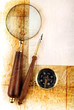 Compass and magnifier  on old textured paper