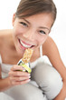 Woman eating muesli bar snack